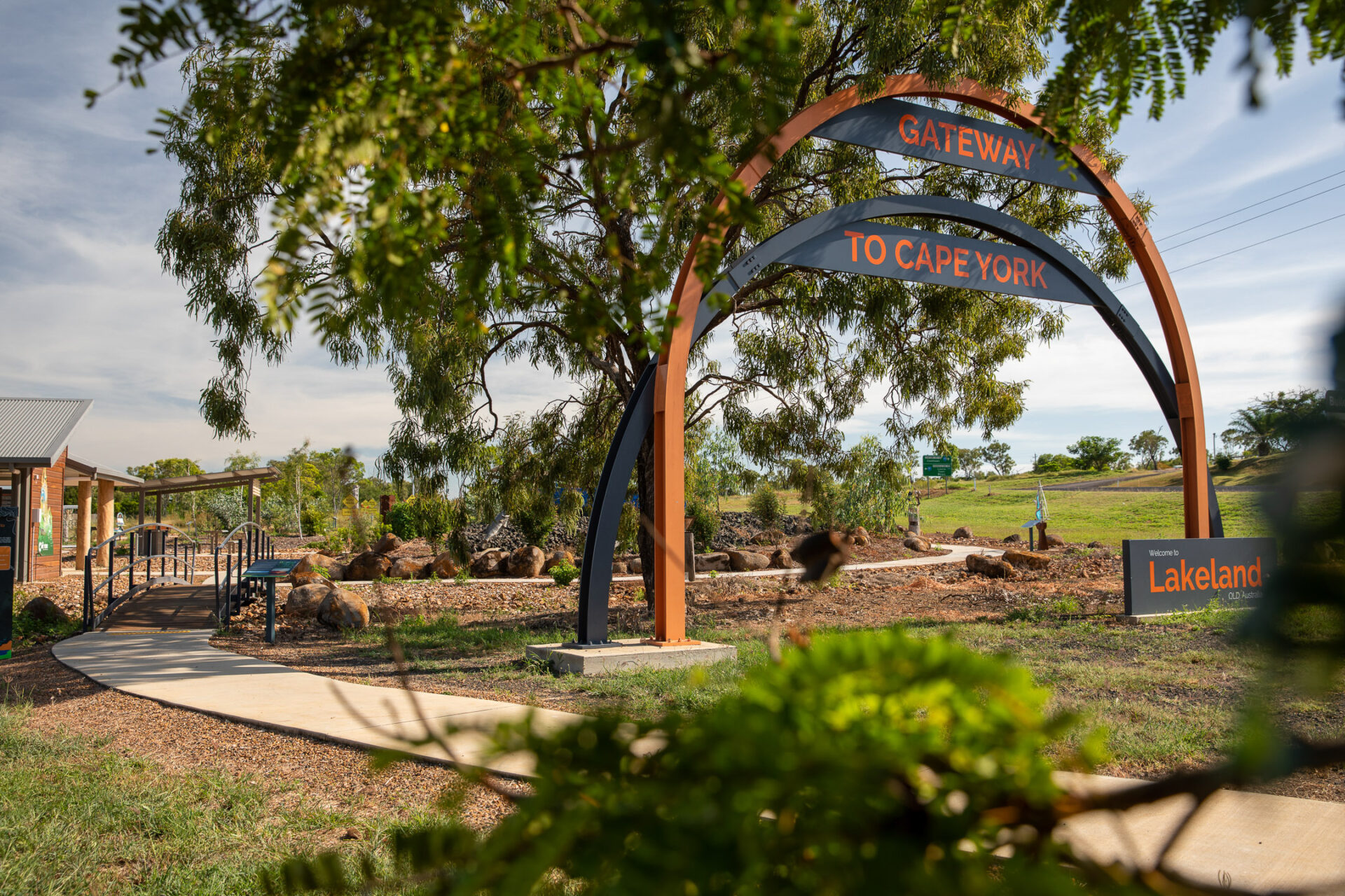 Beautiful shot of the Gateway to Cape York display in Lakeland with lush green trees and a cloud washed sky