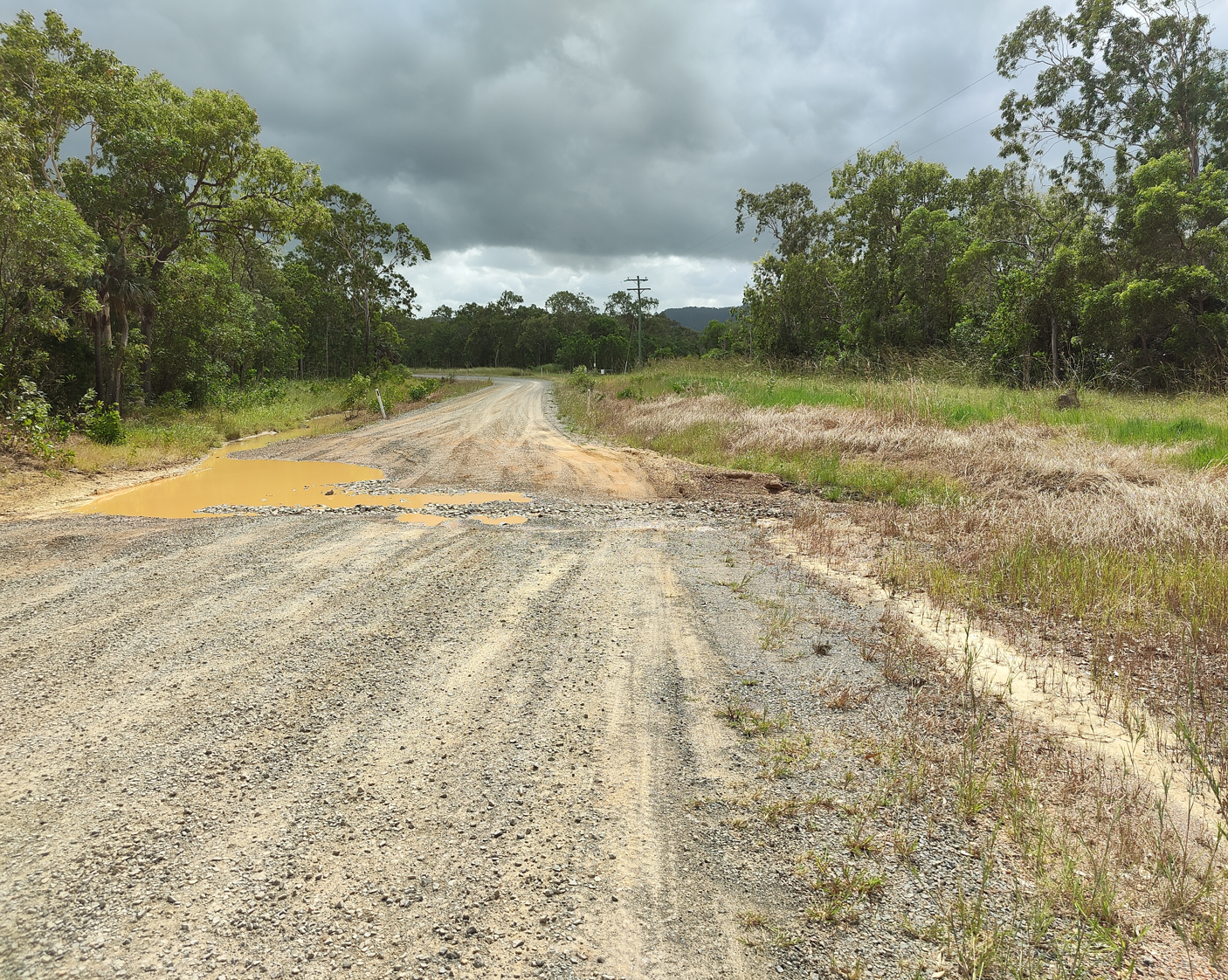 Image of gravel road showing pooling of flood water