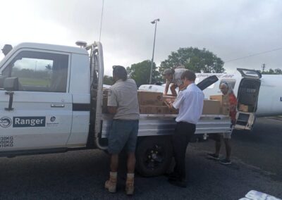 Members of the community unloading Coen's resupply.